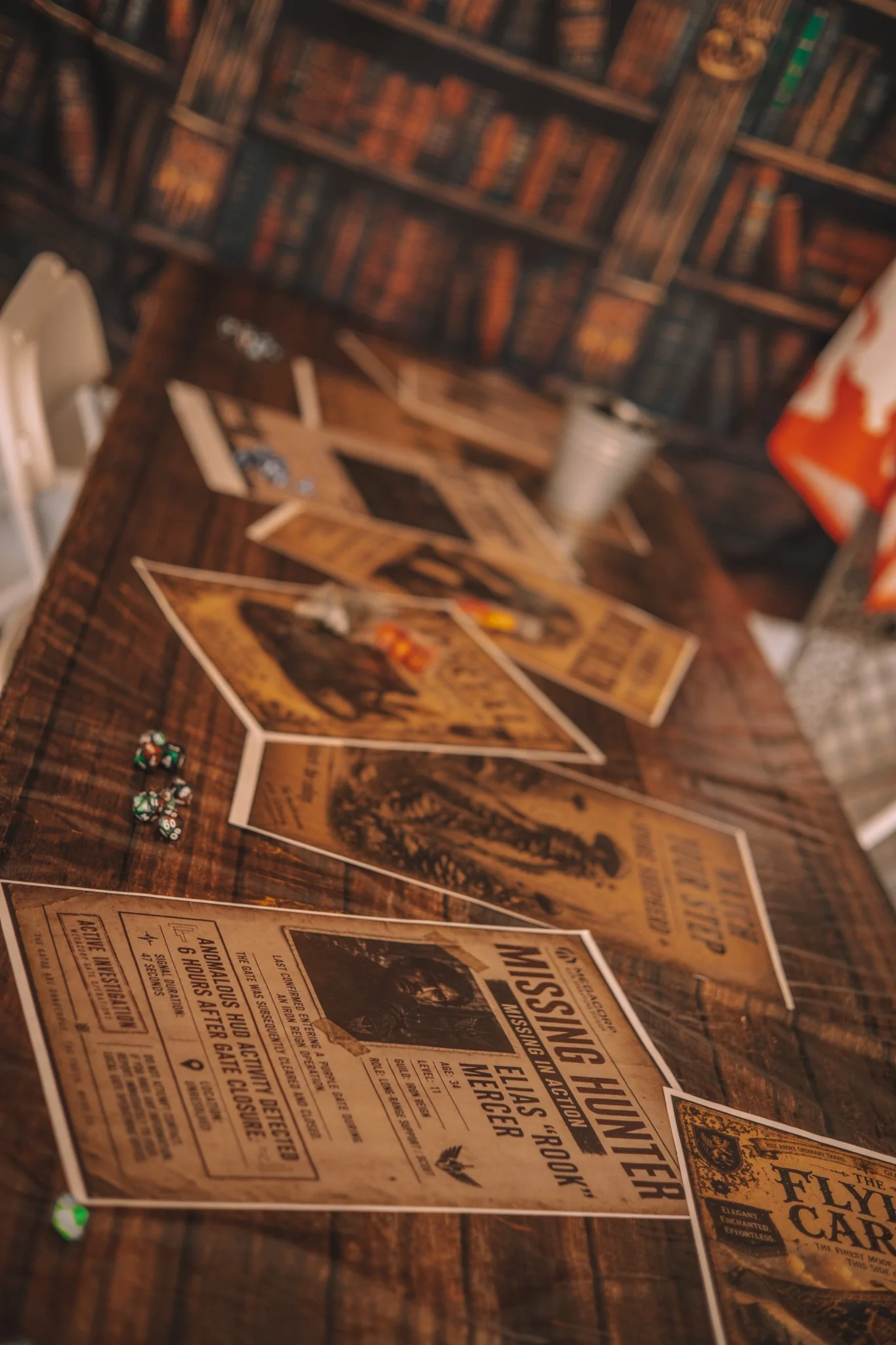 A tabletop covered with illustrated in-world creature and missing-hunter posters.