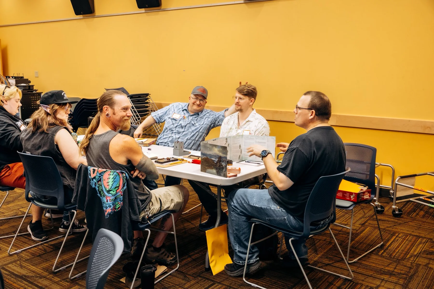 A small group seated around a roleplaying table during a session.